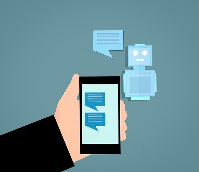 Cartoon of a man's hand holding a mobile telephone and having an online chat.